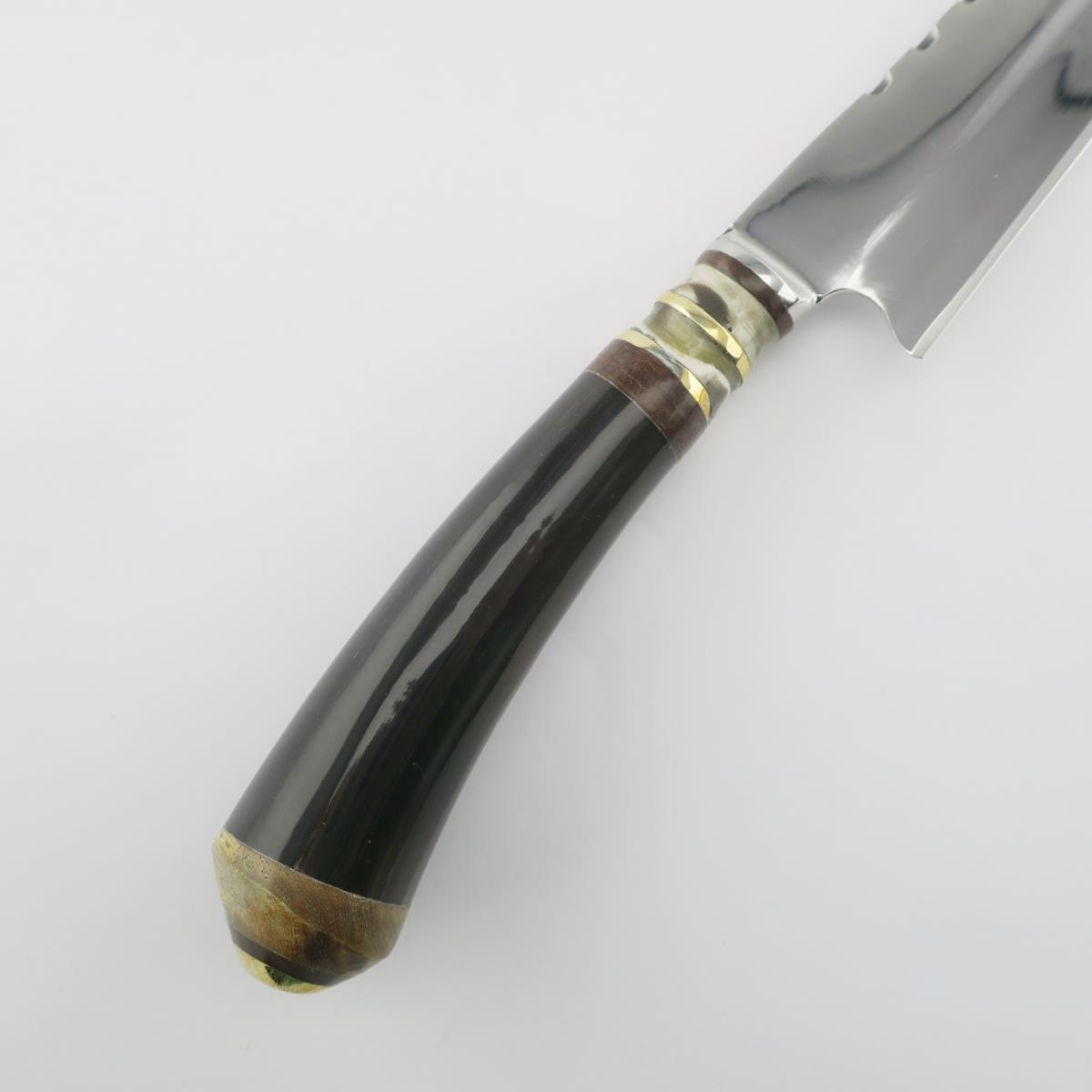 Cuchillo de Acero Inoxidable Cow 5.5 pulgadas Oscuro con hoja pulida y un elegante mango oscuro con detalles de latón y cuerno, ideal para tareas culinarias.