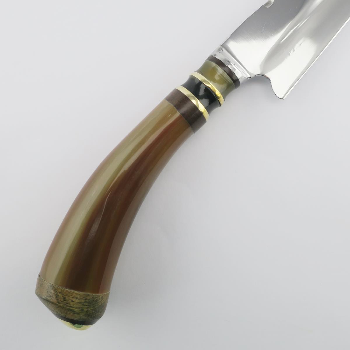 Primer plano de un cuchillo combinado de acero inoxidable de 5.5 pulgadas con mango de cuerno natural y anillos decorativos de latón y madera oscura. Ideal para diversas tareas de cocina, este cuchillo duradero destaca por su artesanía y diseño elegante.