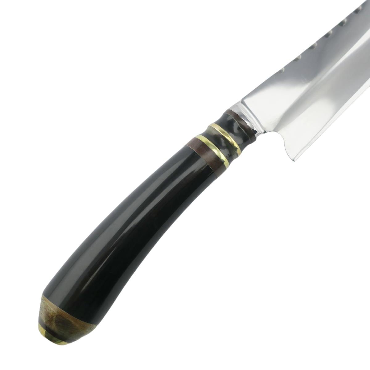 Primer plano de un cuchillo Cow 6.3in Oscuro de acero inoxidable con mango negro y detalles dorados, resaltando su diseño elegante y hoja duradera. Ideal para entusiastas culinarios y chefs profesionales.